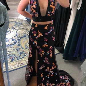 Black 2 piece prom dress with coral, pink and blue appliqué throughout.